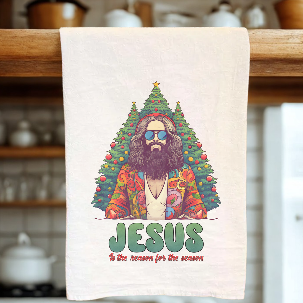 Extra Large tea towel with a colorful design of Jesus under a Christmas tree, hanging on a wooden rack.