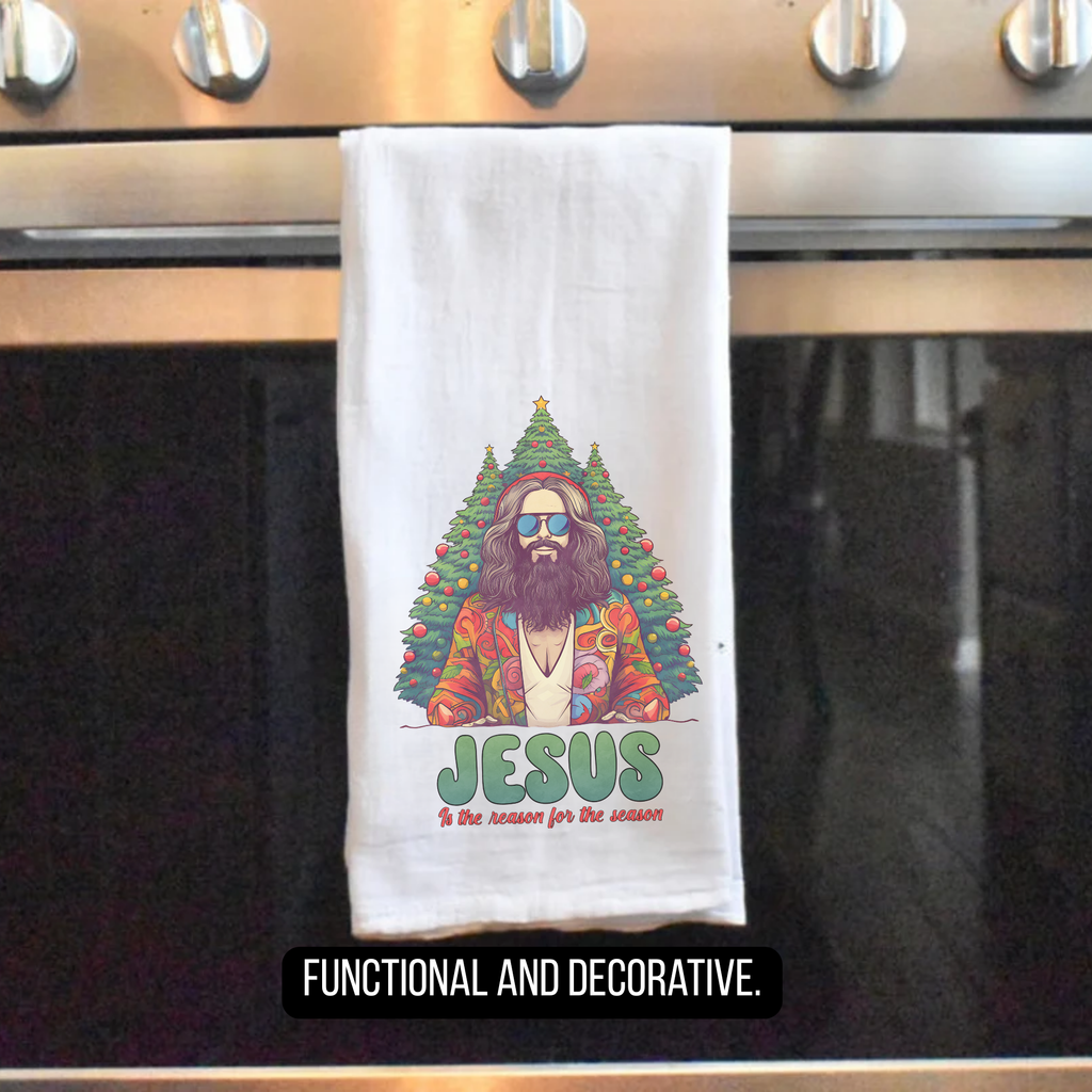 Towel with a Christmas-themed design of Jesus sitting in a tree, hanging on a stove handle.