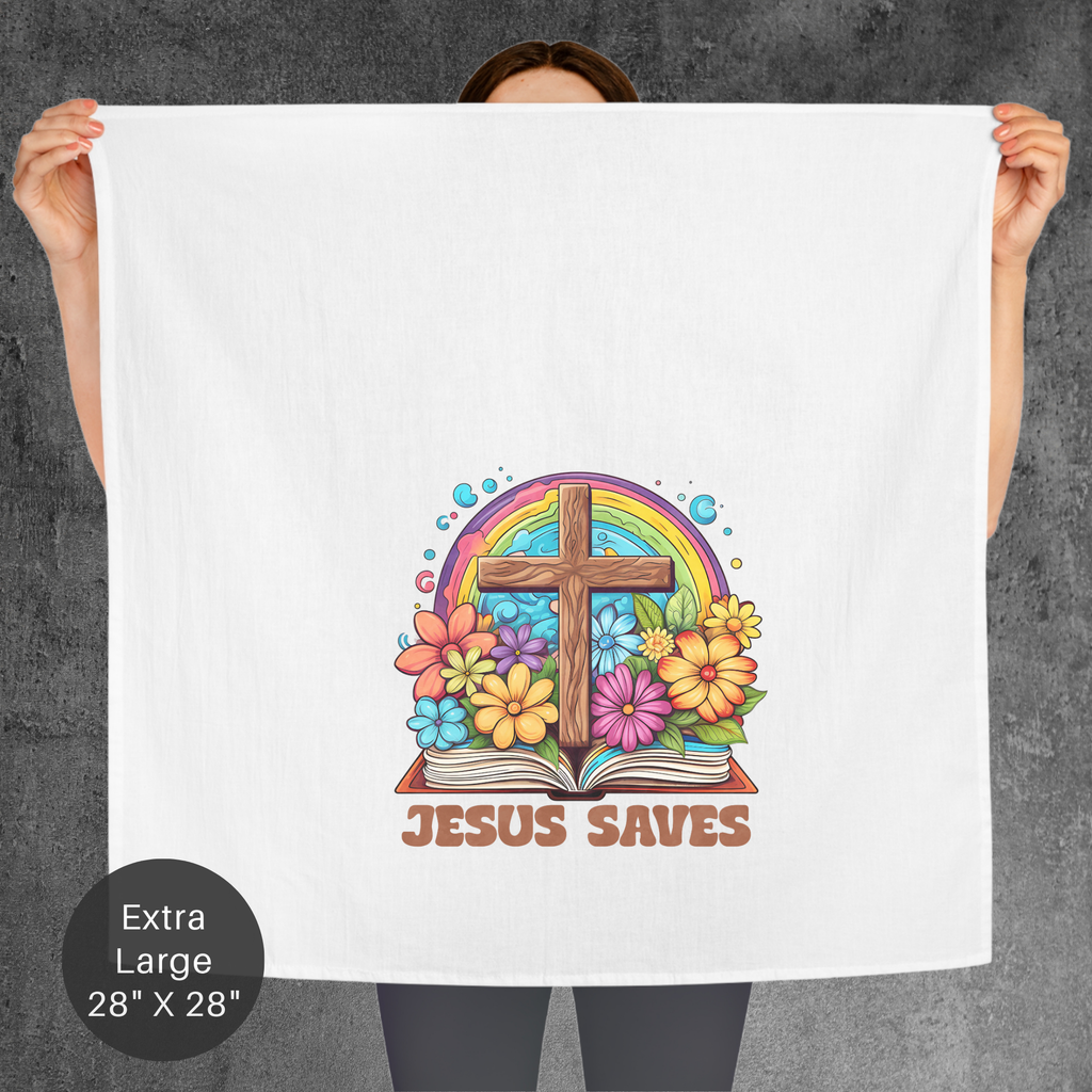 Person holding a tea towel with a colorful design featuring a cross, rainbow, and flowers with 'Jesus Saves' text.