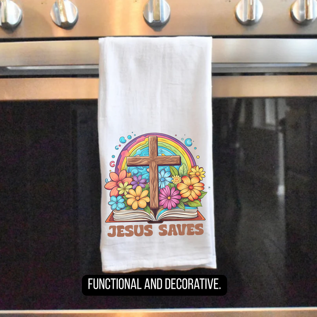 Tea towel with a cross and rainbow design hanging on an oven handle, labeled 'Jesus Saves'.
