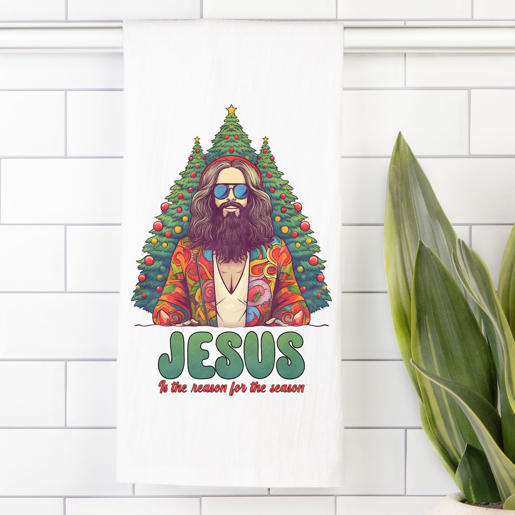 Tea towel with an illustration of a colorful Jesus figure with a Christmas tree, on a white tiled wall.