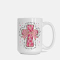 White mug with pink cross and bow design on a white background
