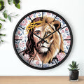 Round black wall clock with a design of a lion's head and Jesus' face, surrounded by floral patterns on a white wall.