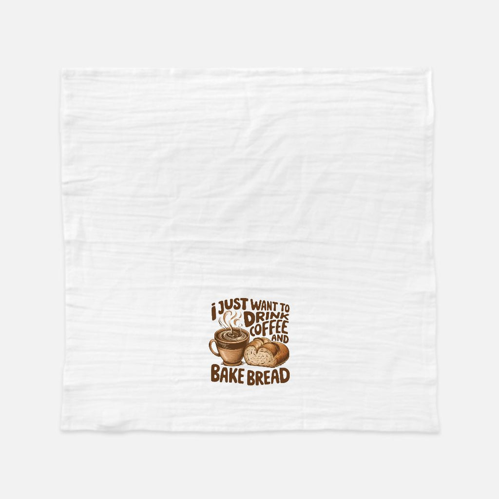 White tea towel with a graphic of a coffee cup and bread and text 'I just want to drink coffee and bake bread' on a white background.