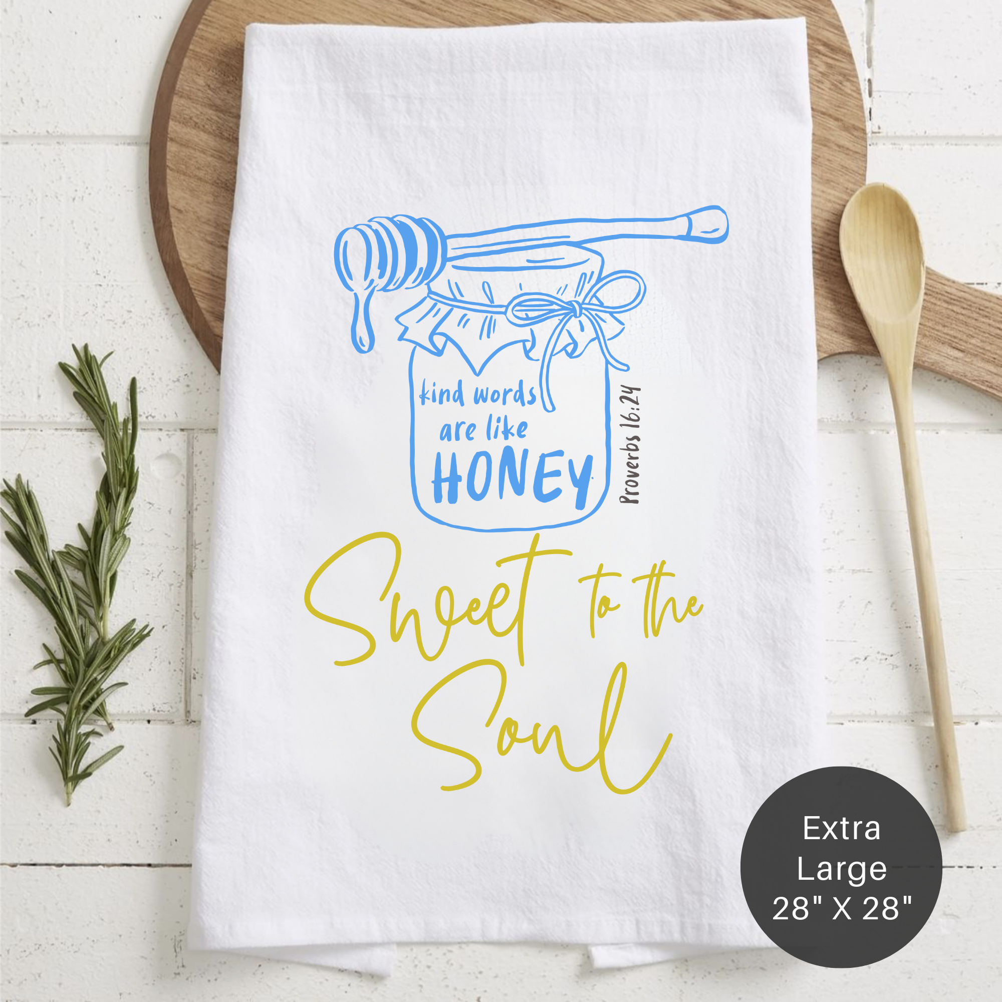 White towel with blue and yellow design on a wooden surface