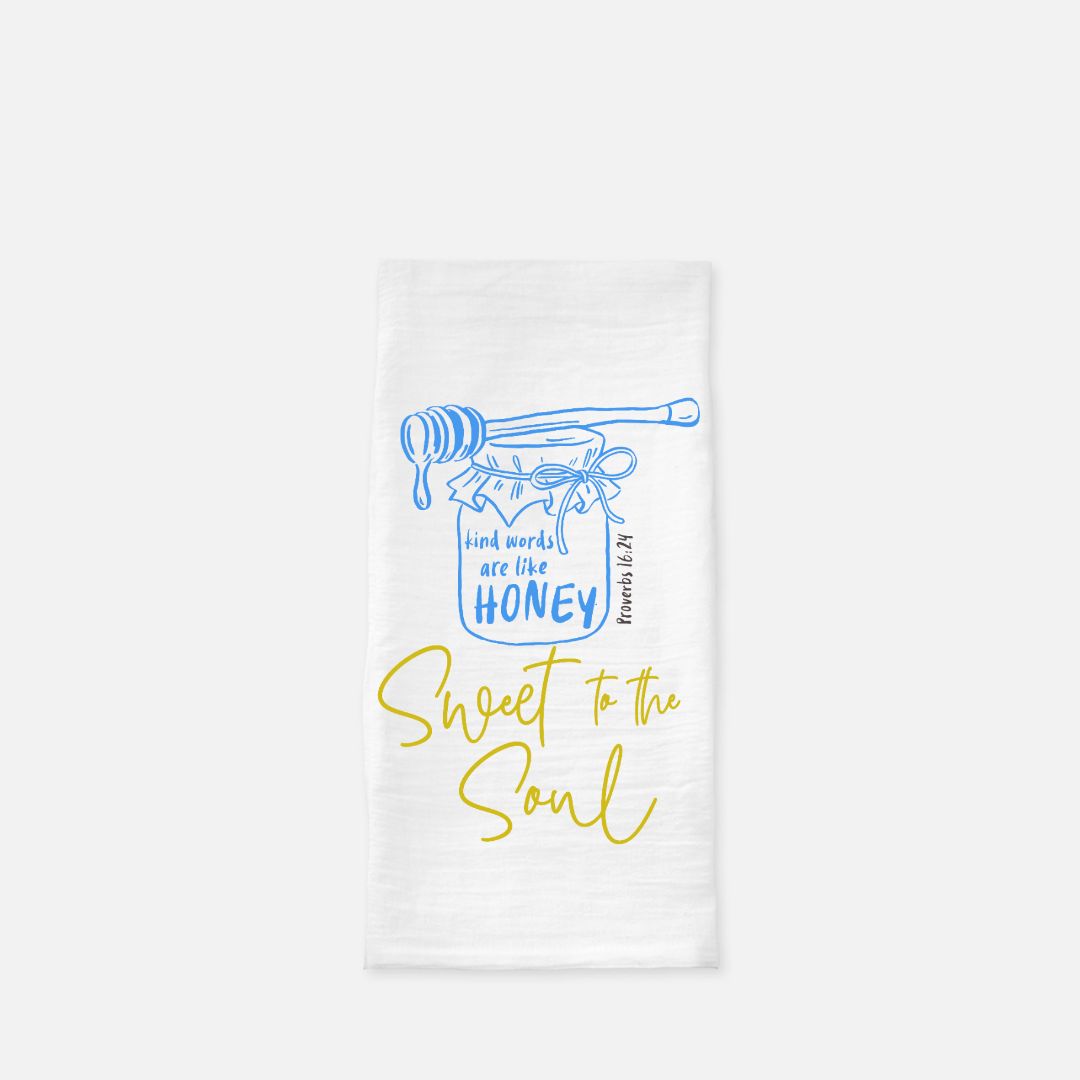 White tea towel with blue and yellow design featuring a jar of honey and text on a white background