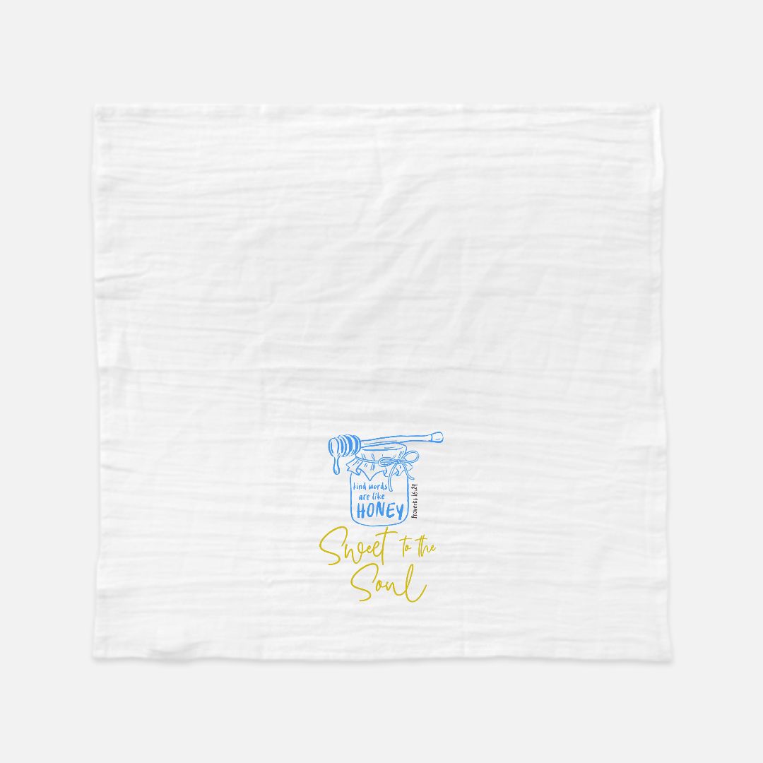 White tea towel with blue and yellow text and design on a white background