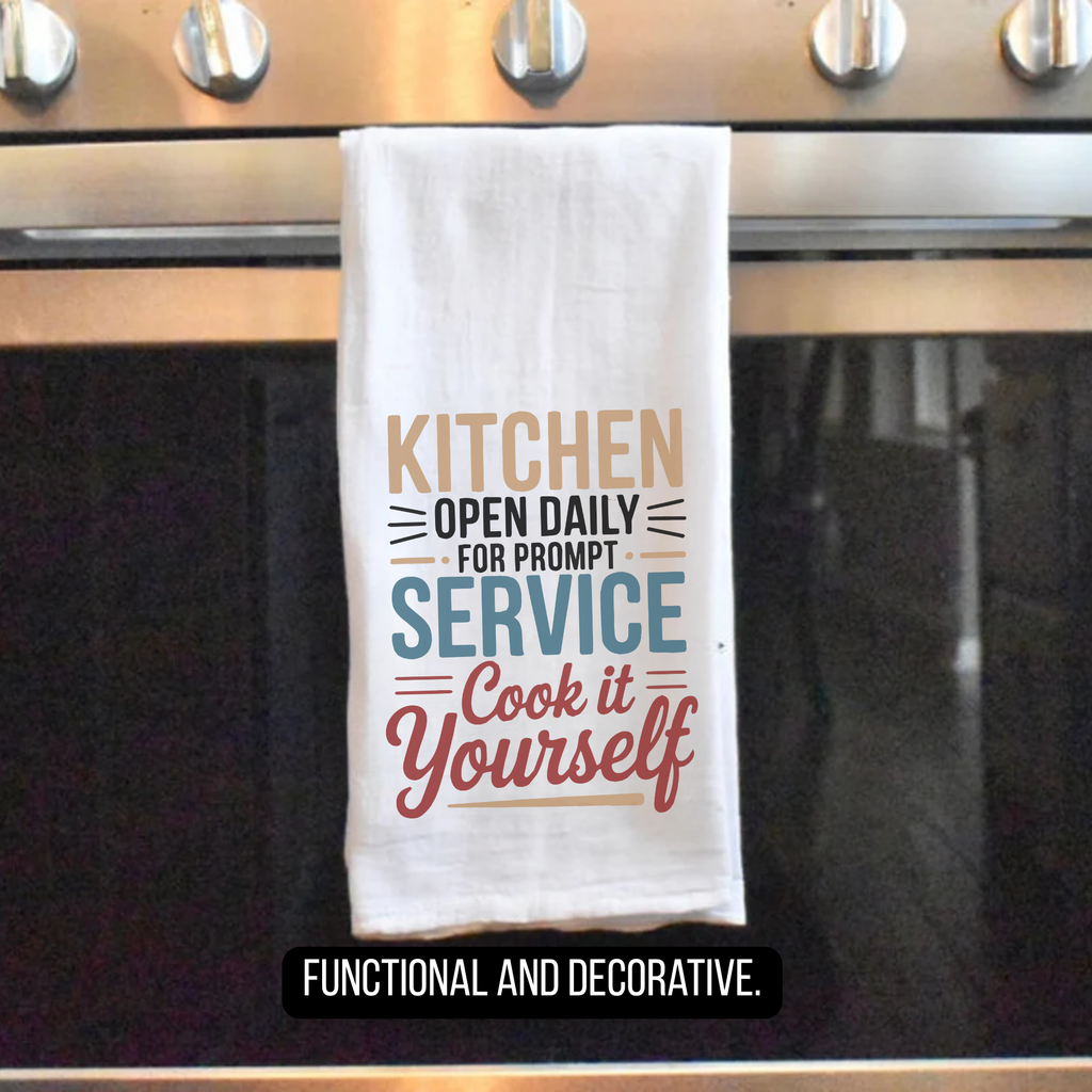 Kitchen towel with humorous text hanging on a stove handle