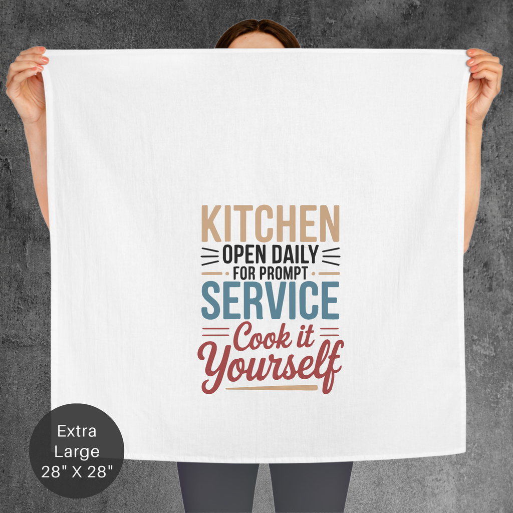 Person holding an extra large tea towel with humorous kitchen quote design against a gray background