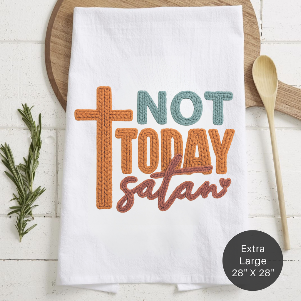 White tea towel with 'Not Today Satan' text and cross design on a wooden surface.