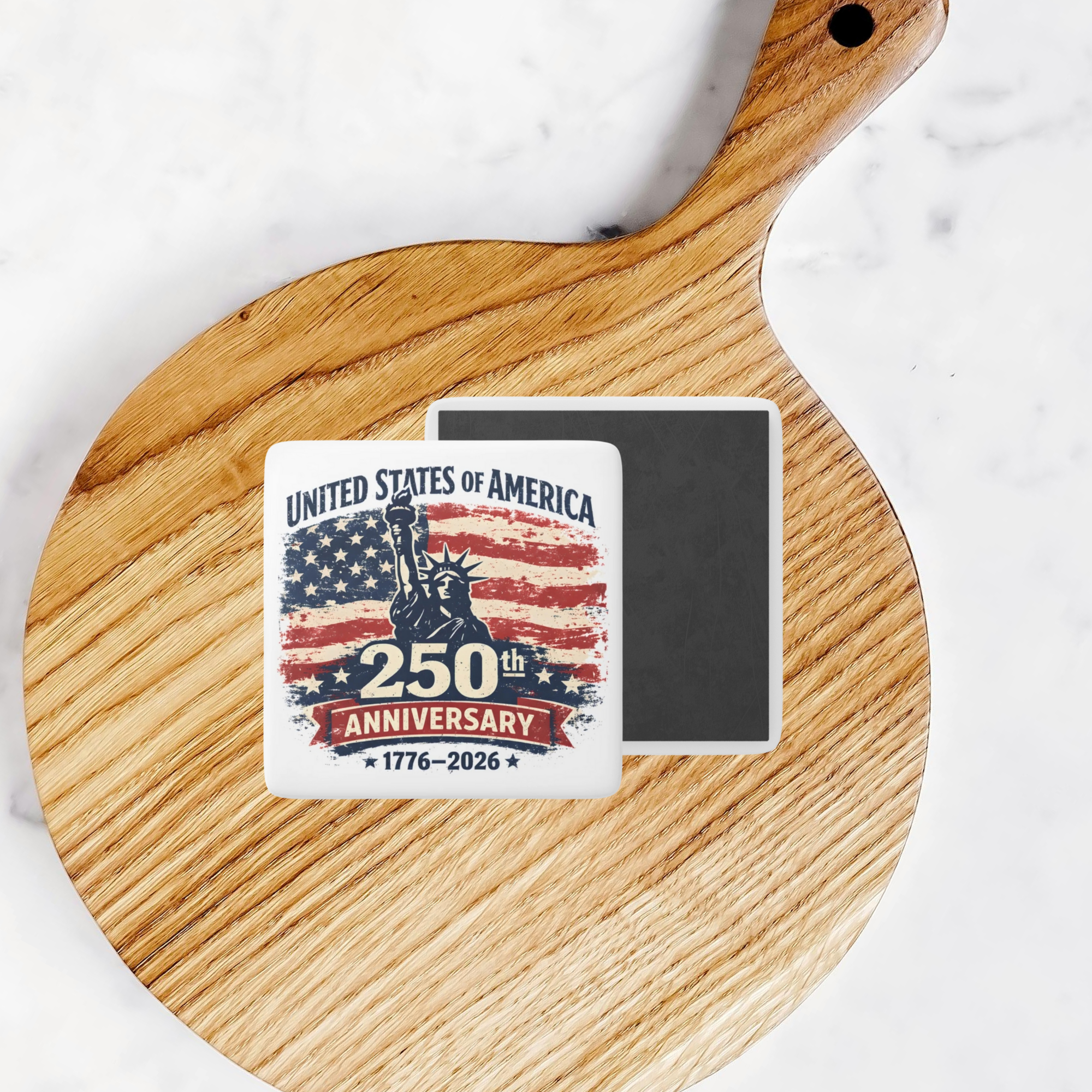 250th Anniversary of the United States of America magnet on a wooden cutting board.