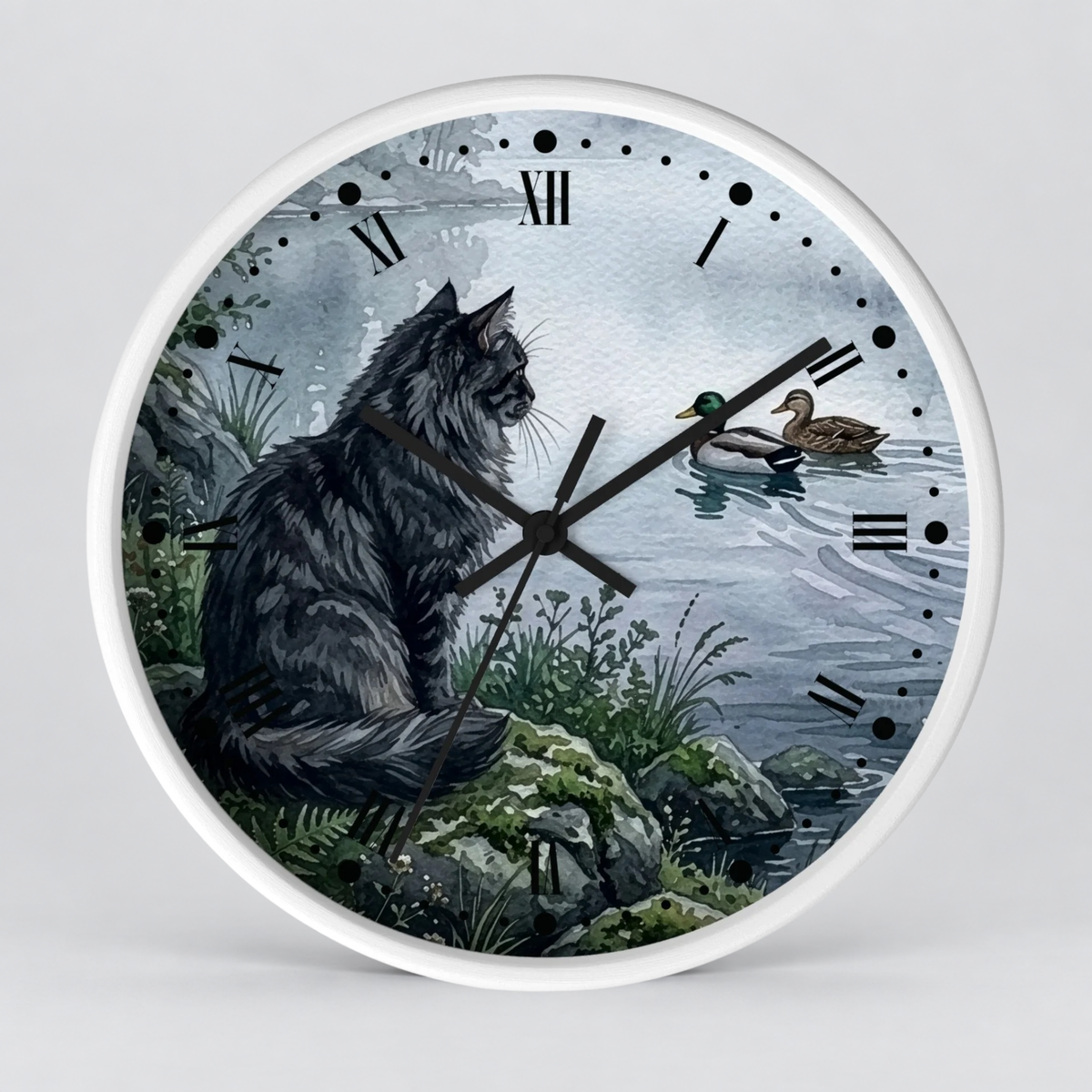 A round wall clock with a white frame and a printed scenic face showing a large black cat sitting on rocks by the water, with a duck floating on the lake and Roman numeral hour markers.