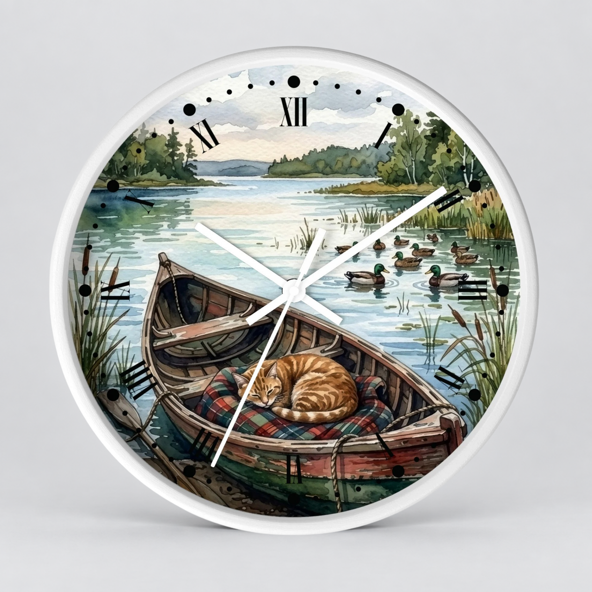 Round wall clock with a white frame and a scenic illustration of a cat sleeping in a wooden boat on a lake, with ducks and trees in the background. Roman numerals mark the hours, and the clock hands are white.