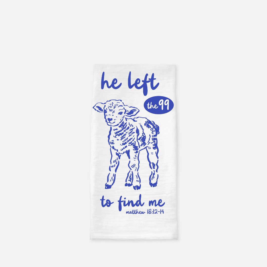 White towel with blue lamb illustration and text on a white background