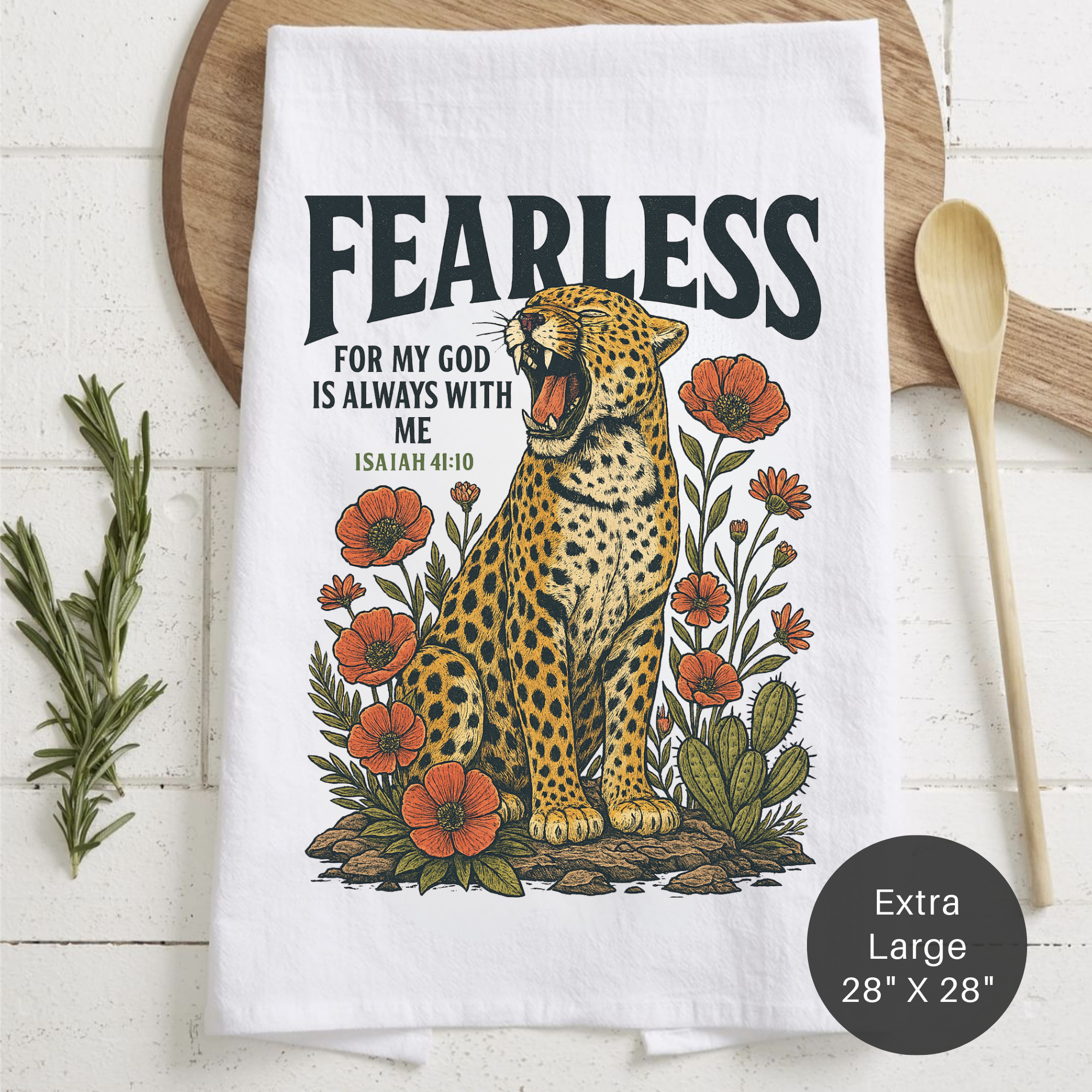 Tea towel with a leopard illustration and 'Fearless' text on a wooden surface.