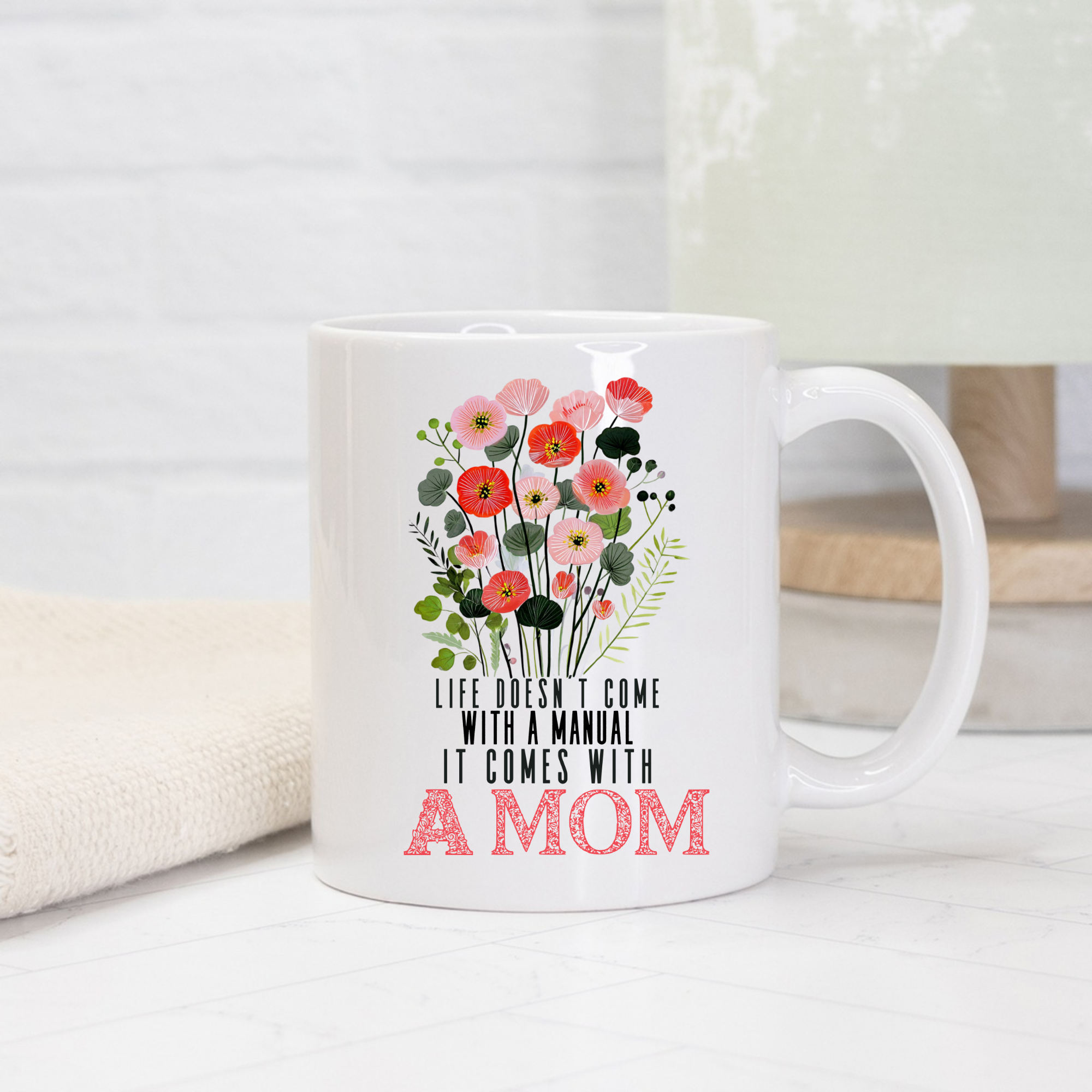 White 11oz mug with floral design and text on a light background