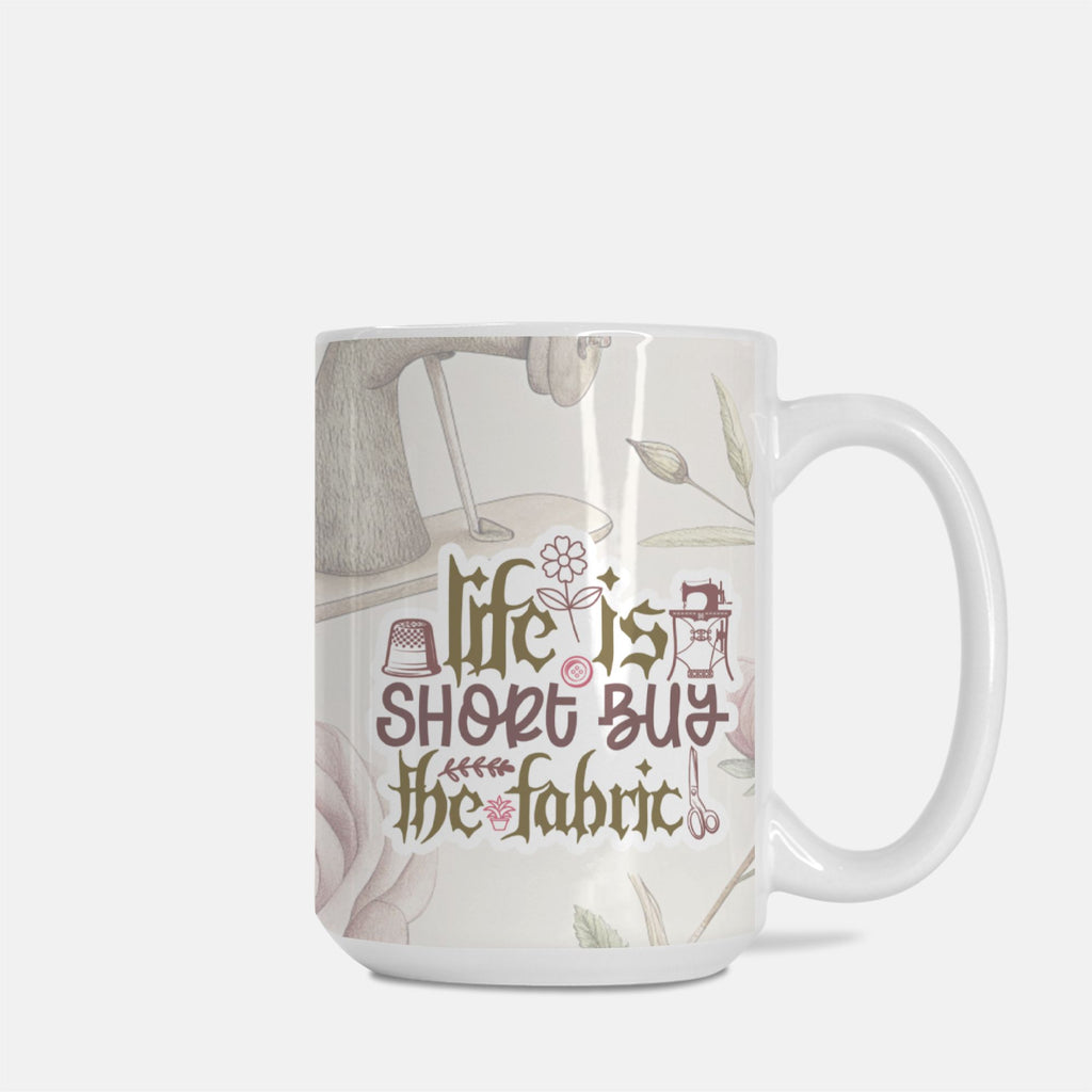 Mug with 'Life is short, buy the fabric' text and sewing-themed design on a white background