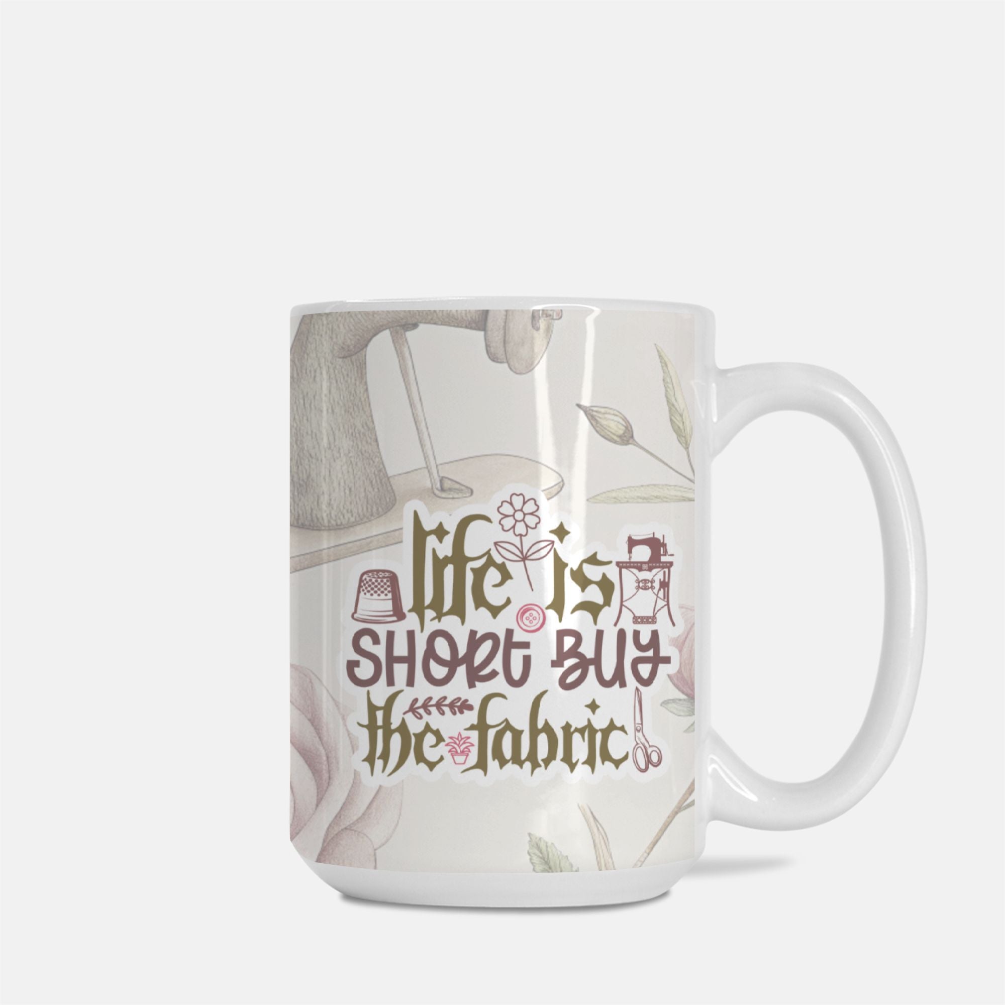 Mug with 'Life is short, buy the fabric' text and sewing-themed design on a white background