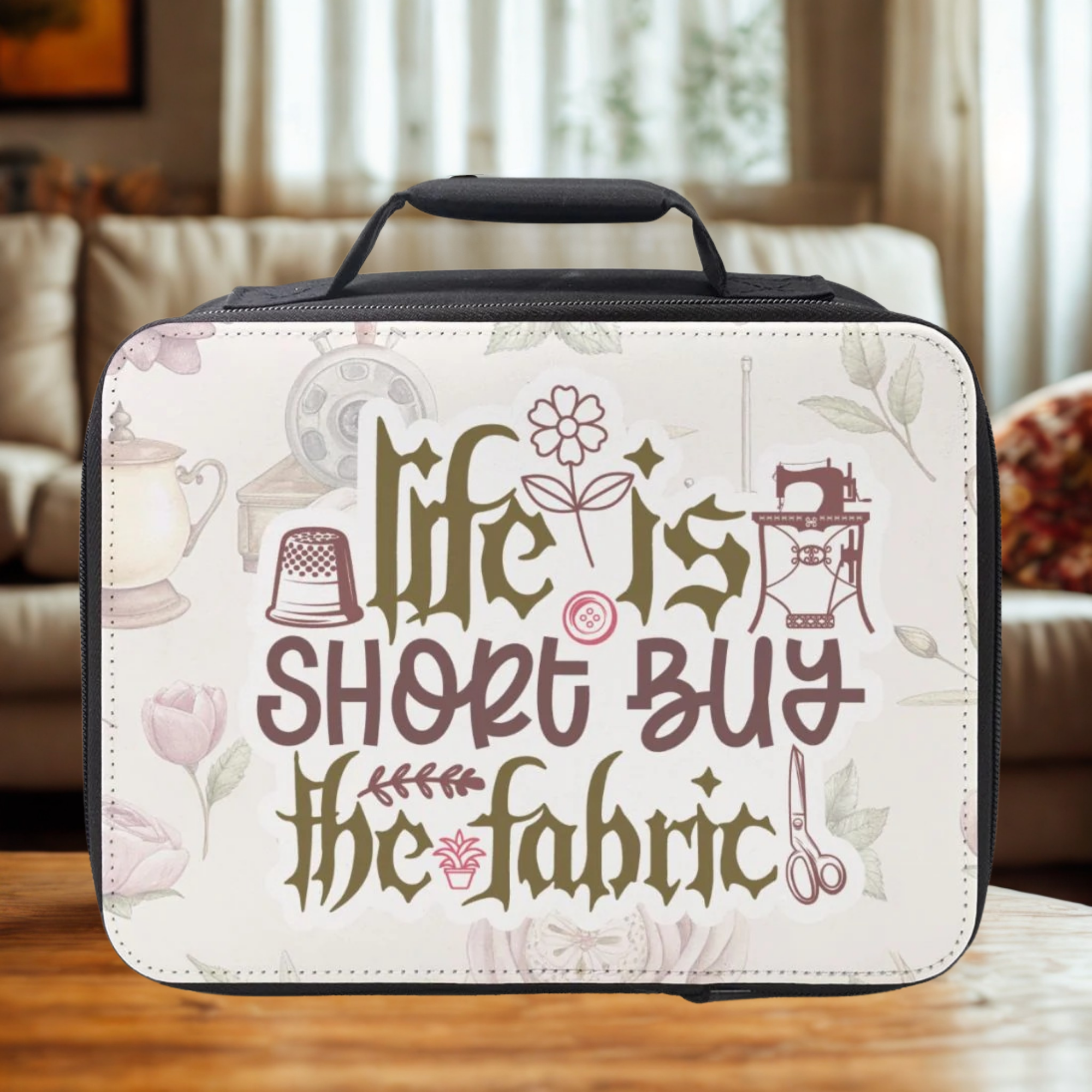 Insulated lunch bag with decorative text and sewing-themed graphics on a wooden surface.