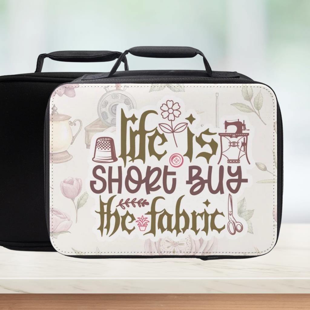 Insulated lunch box with sewing-themed design and text on a blurred background