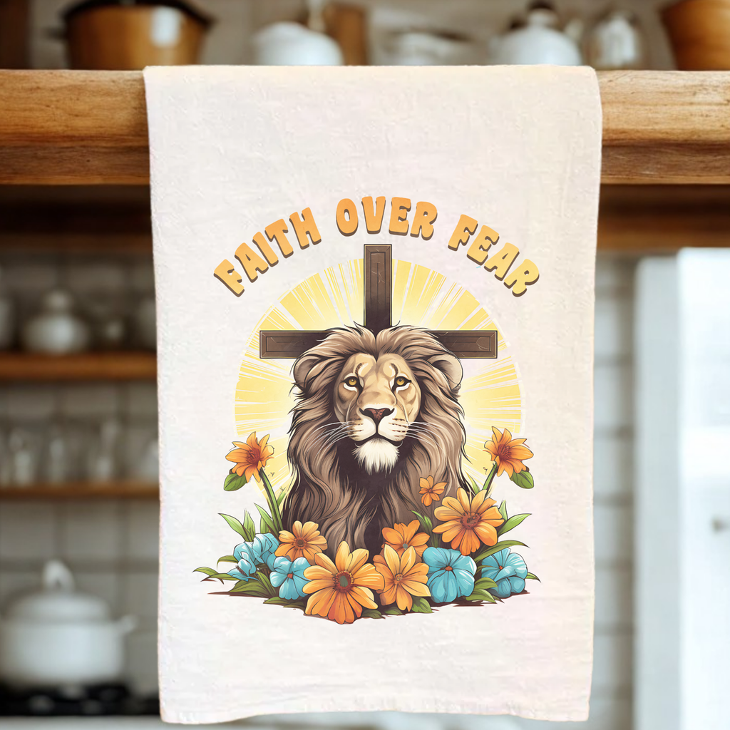 Decorative tea towel with a lion, cross, and flowers design on a wooden rack.