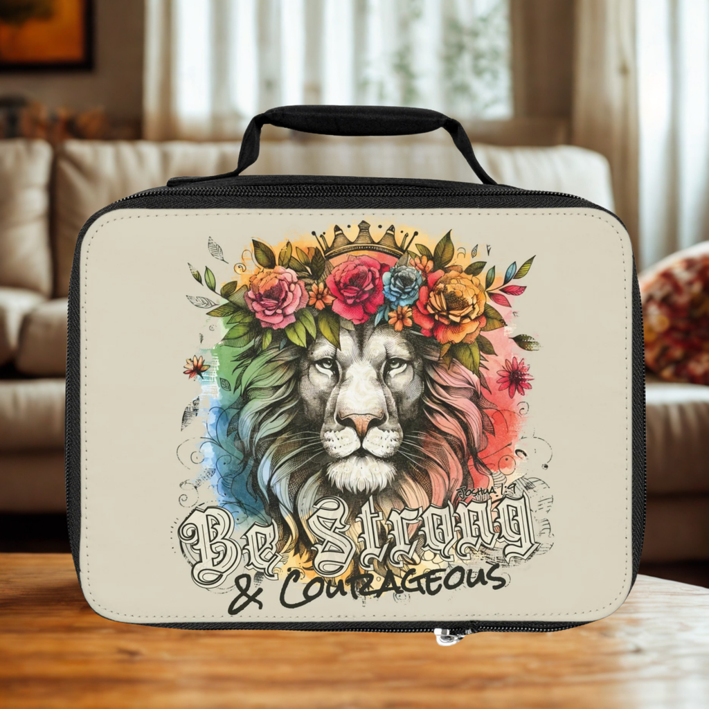  insulated lunch bag with a lion design and 'Be Strong & Courageous' text on a wooden surface.