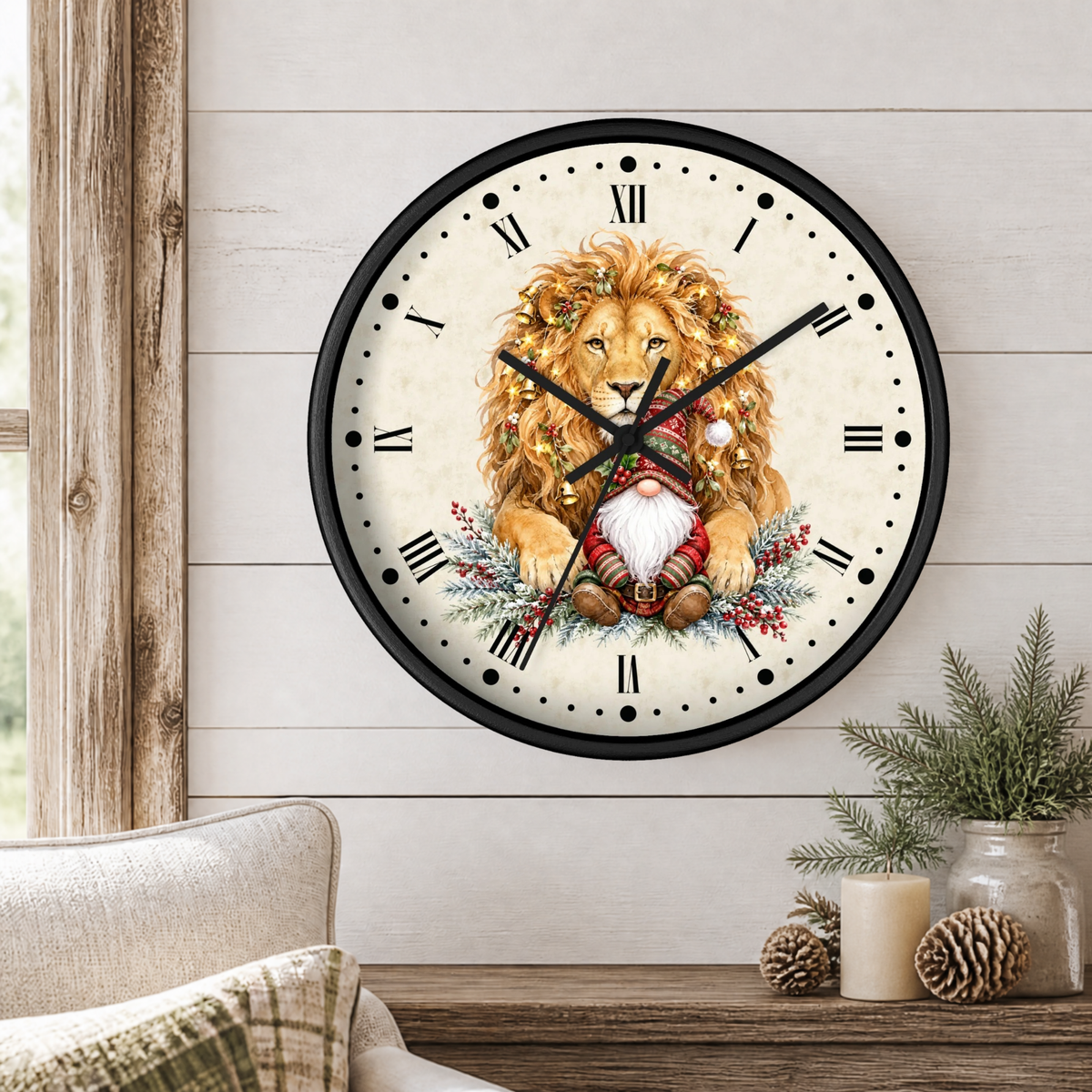 A round wall clock with a black frame and a festive Christmas-themed lion illustration on the face, mounted on a white wood paneled wall above a rustic table with candles and pinecones.
