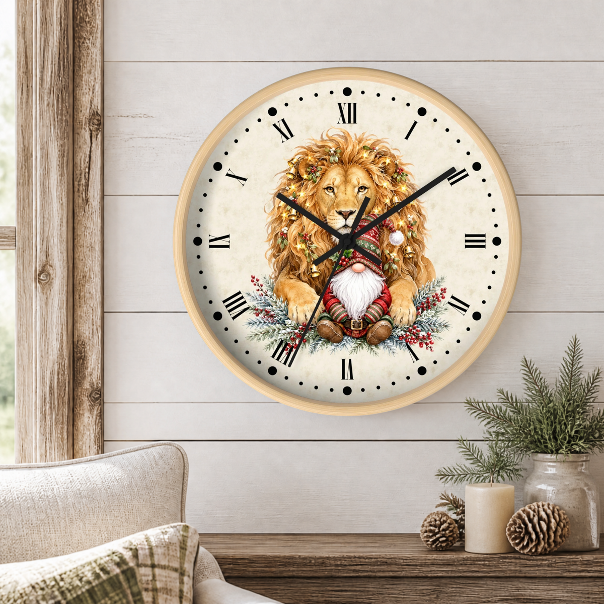 A round wall clock with a light wood frame hangs on a white shiplap wall above a wooden table. The clock face features an illustration of a golden lion wearing a floral crown and a Santa-style gnome in the center, with black Roman numerals and black hands.