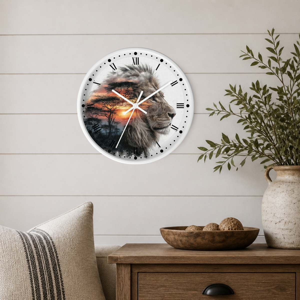 A round wall clock with a white frame hangs on a light wood paneled wall above a wooden side table. The clock face features a photographic lion portrait with a sunset sky overlay.