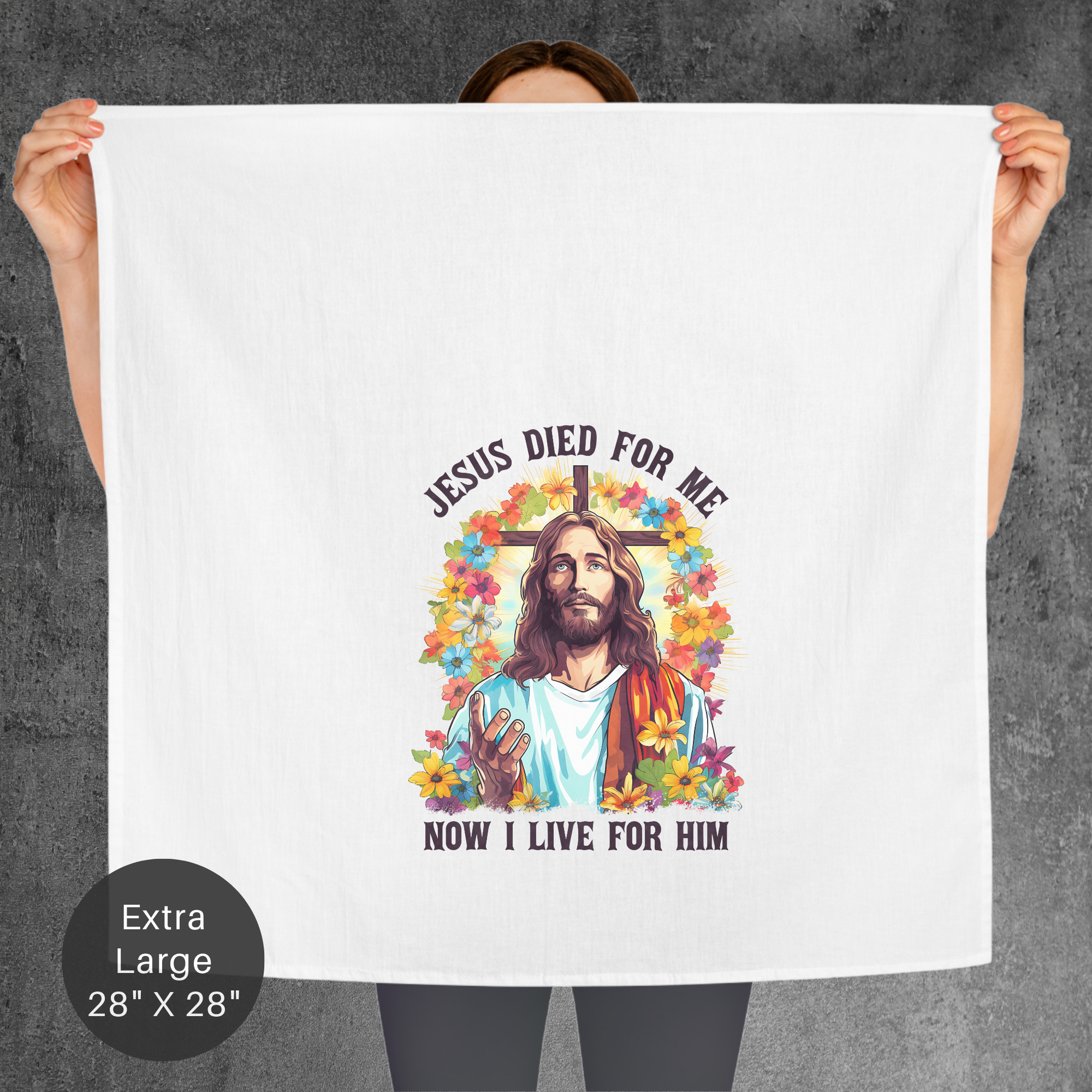 Person holding a towel with a graphic of Jesus and text on a gray background