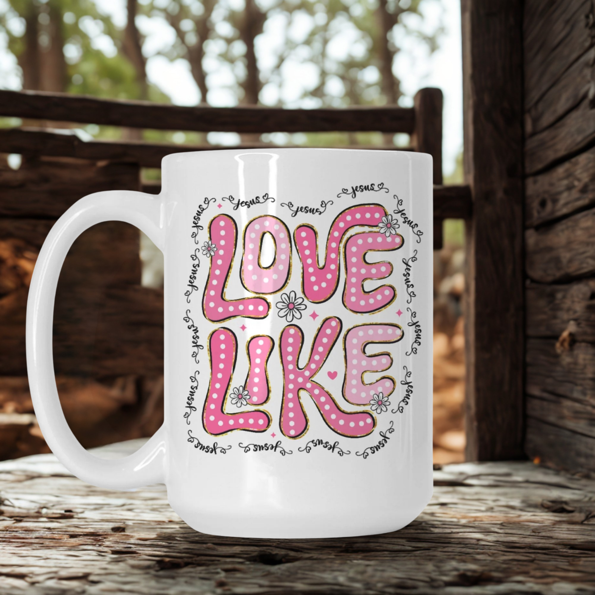 White mug with pink 'LOVE LIKE' text on a wooden surface