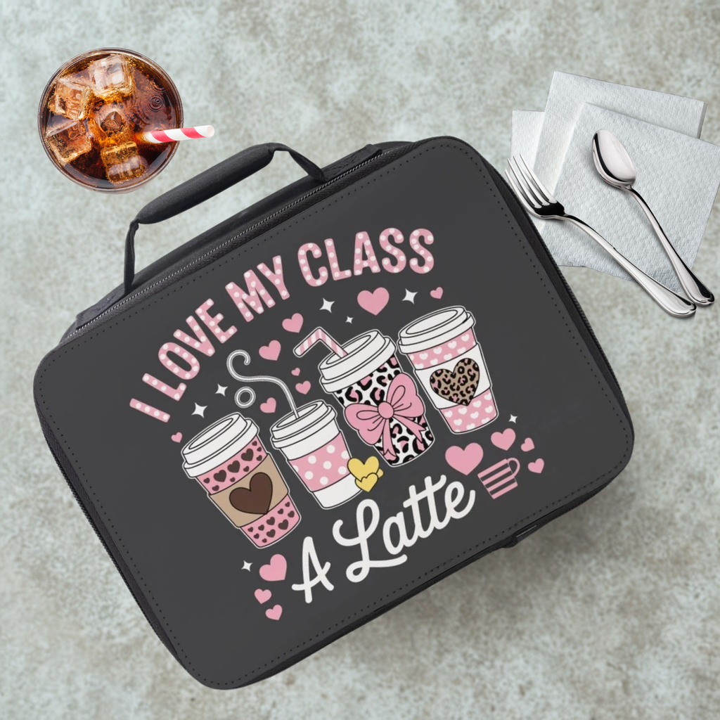 Black lunch bag with 'I love my class a latte' design on a gray table with a drink and utensils.