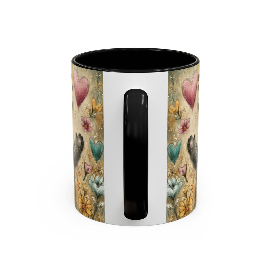 Back side of an 11oz. black accent mug with floral and heart design on a white background