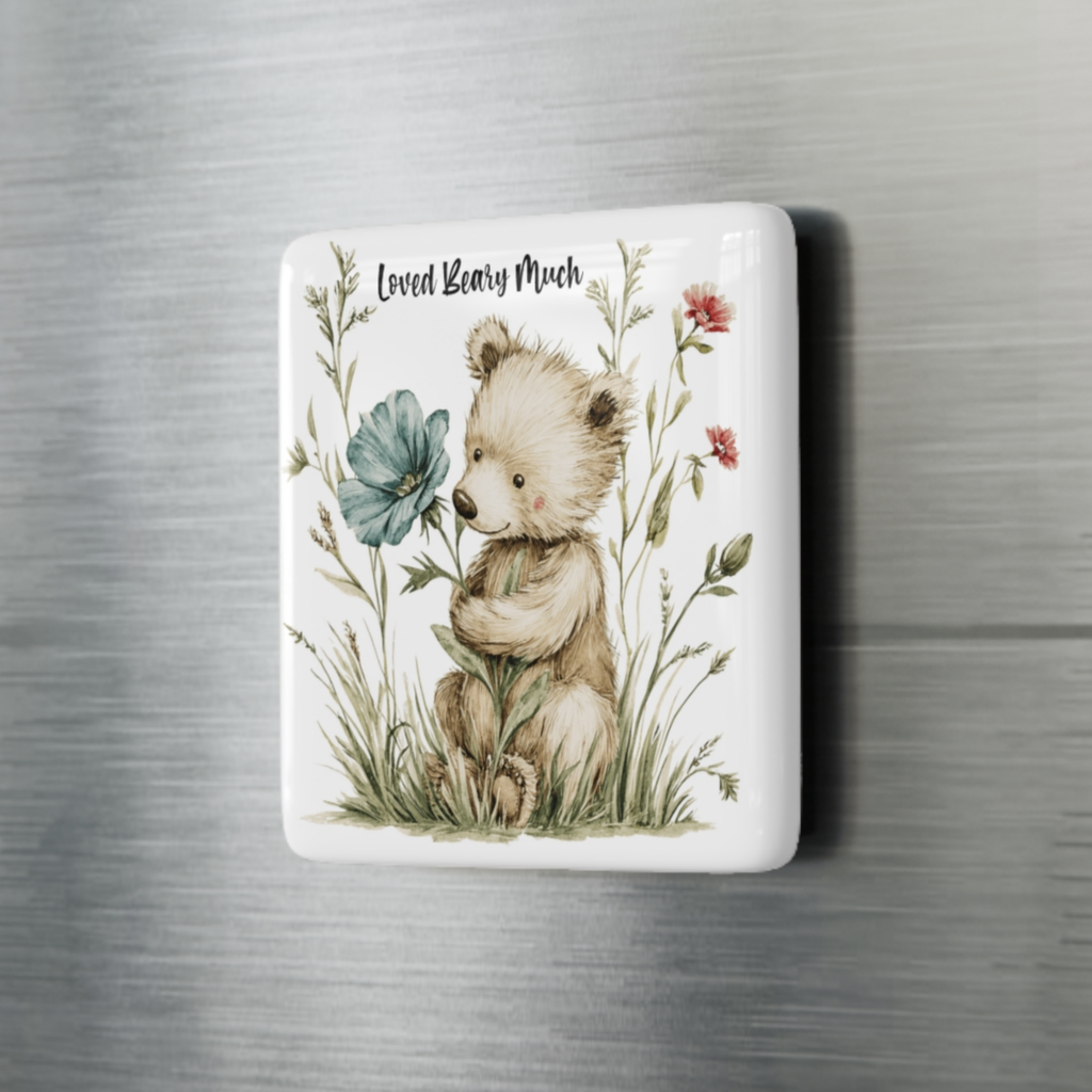 Fridge magnet with a bear and floral design on a metallic surface