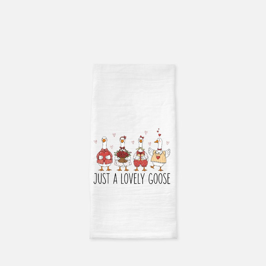 Tea towel with cartoon geese design and text 'Just a Lovely Goose' on a white background