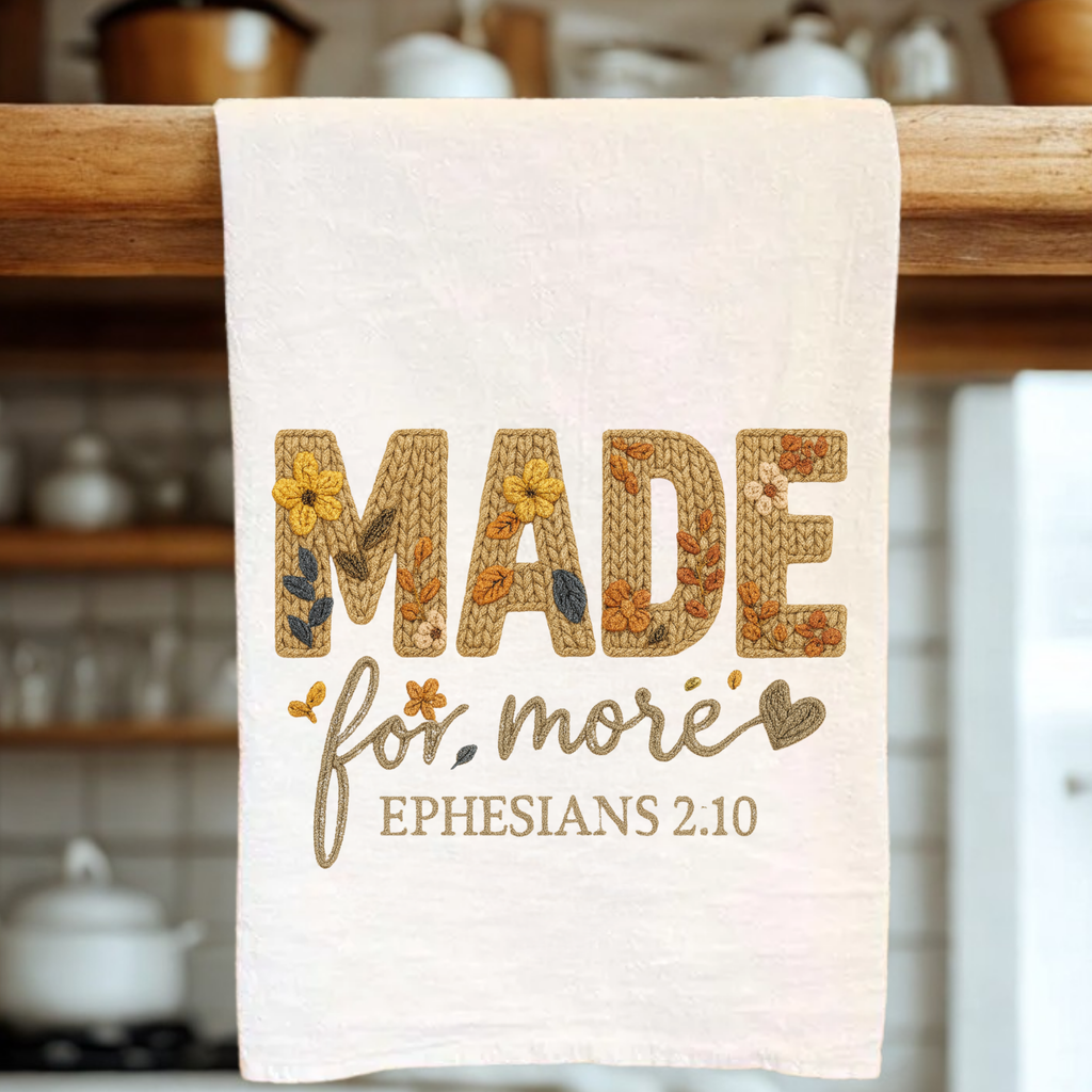 Decorative towel with embroidered text in a kitchen setting