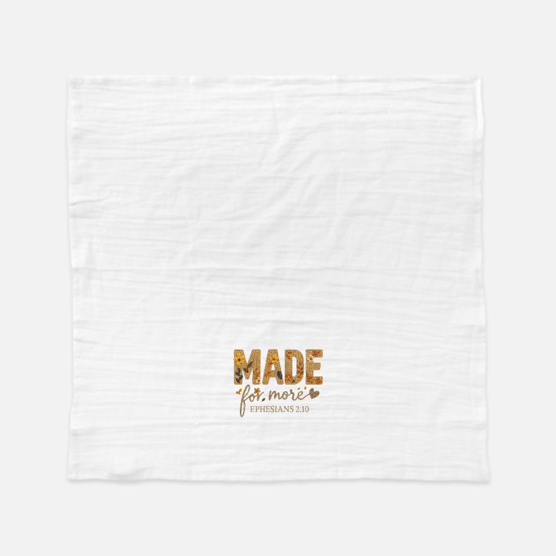 White towel with gold text 'MADE for more Ephesians 2:10' on a white background