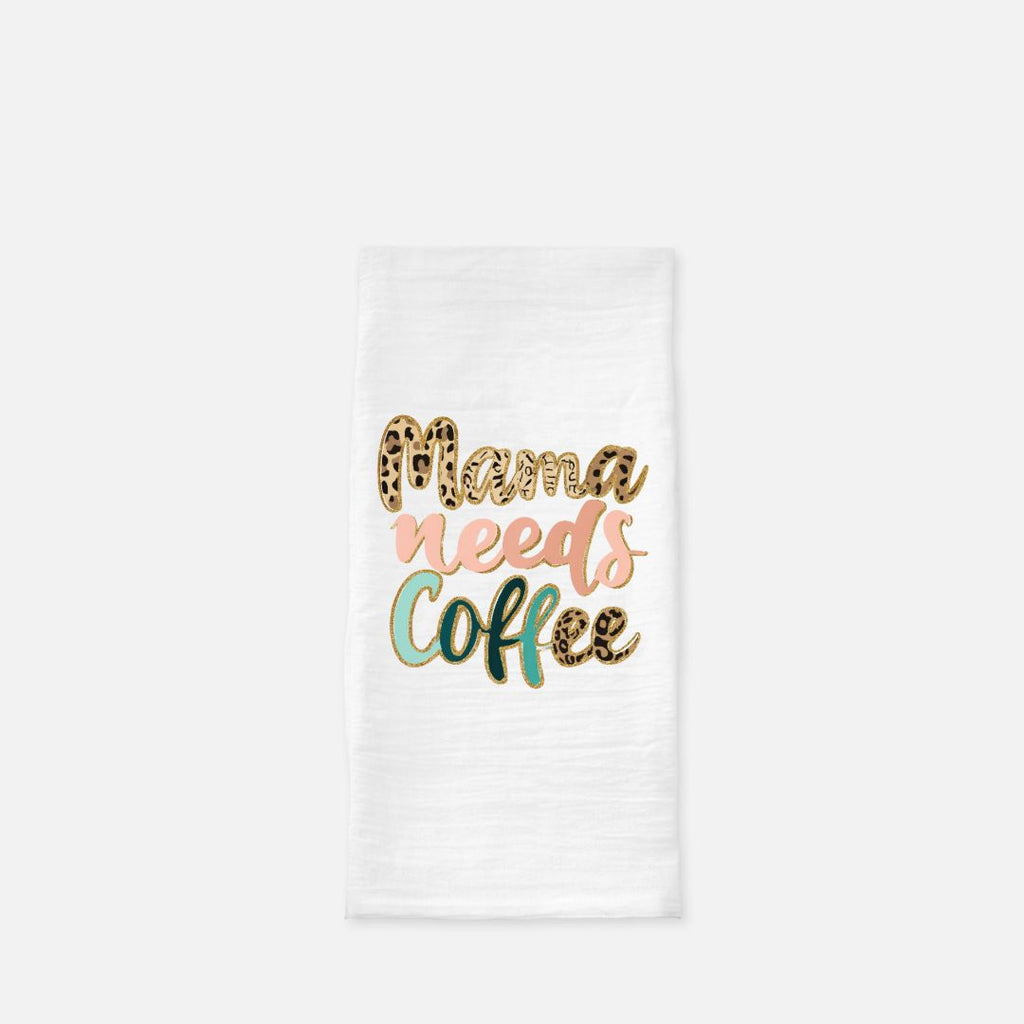 White towel with 'Mama Needs Coffee' text in colorful letters on a white background