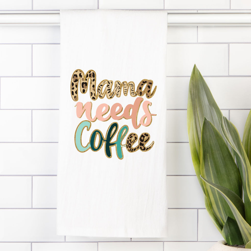 Decorative sign with 'Mama needs Coffee' text on a white tiled wall.