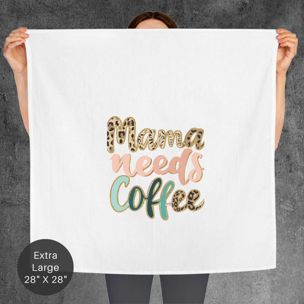 Person holding a towel with 'Mama needs coffee' text in gold, pink, and green on a gray background