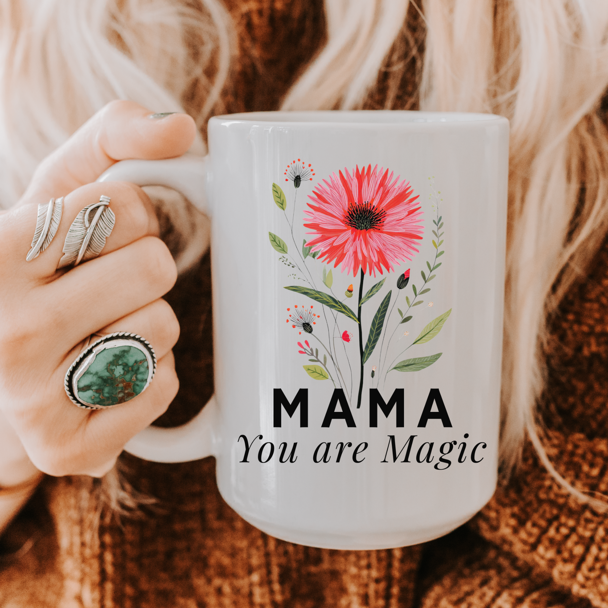 Person holding a 15oz mug with floral design and 'MAMA You are Magic' text