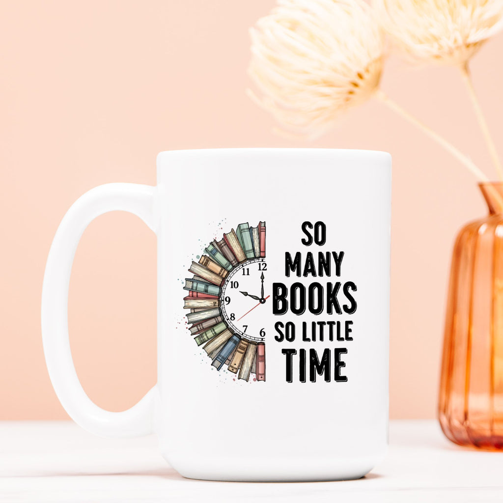 White mug with a clock design and 'So Many Books So Little Time' text on a peach background