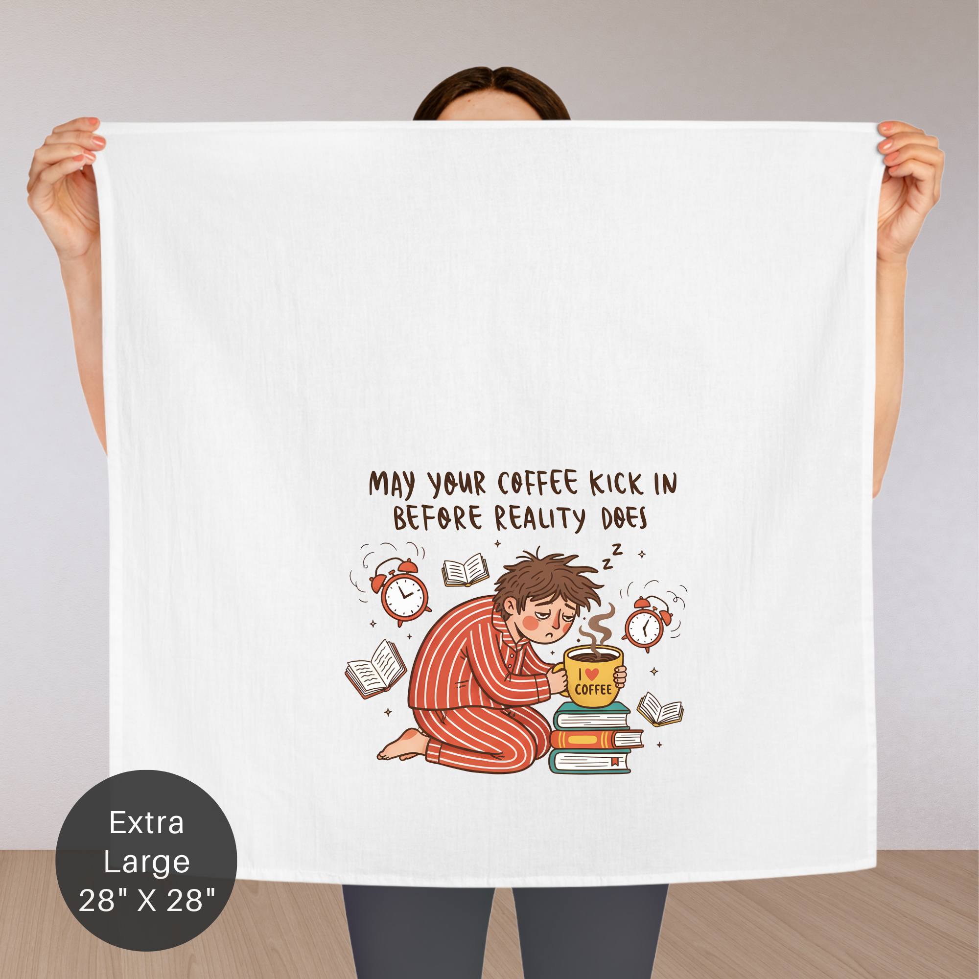 Person holding an extra large white tea towel with a humorous illustration and text.