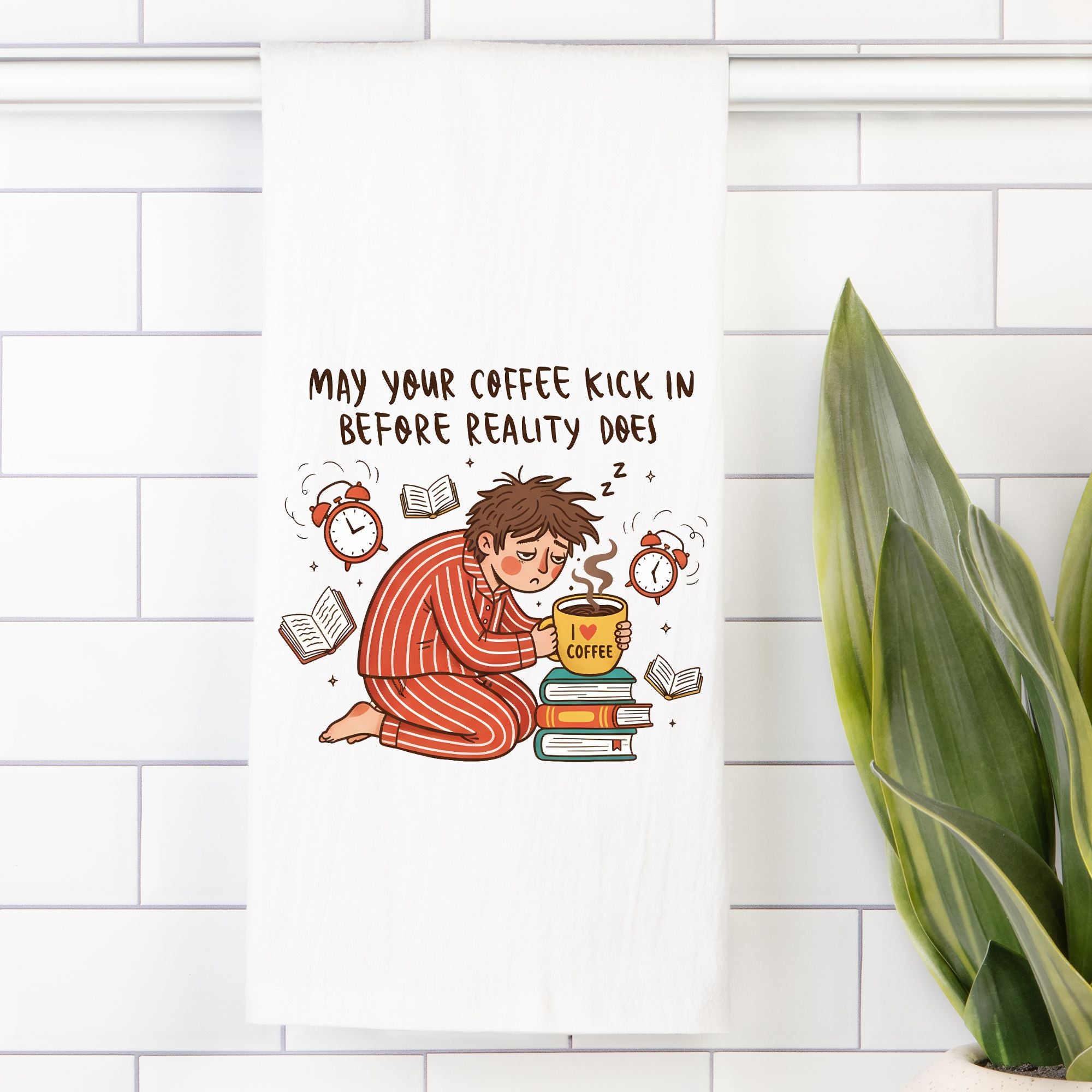 Tea towel with an Illustration of a person in pajamas holding a coffee cup with text on a white tiled wall.