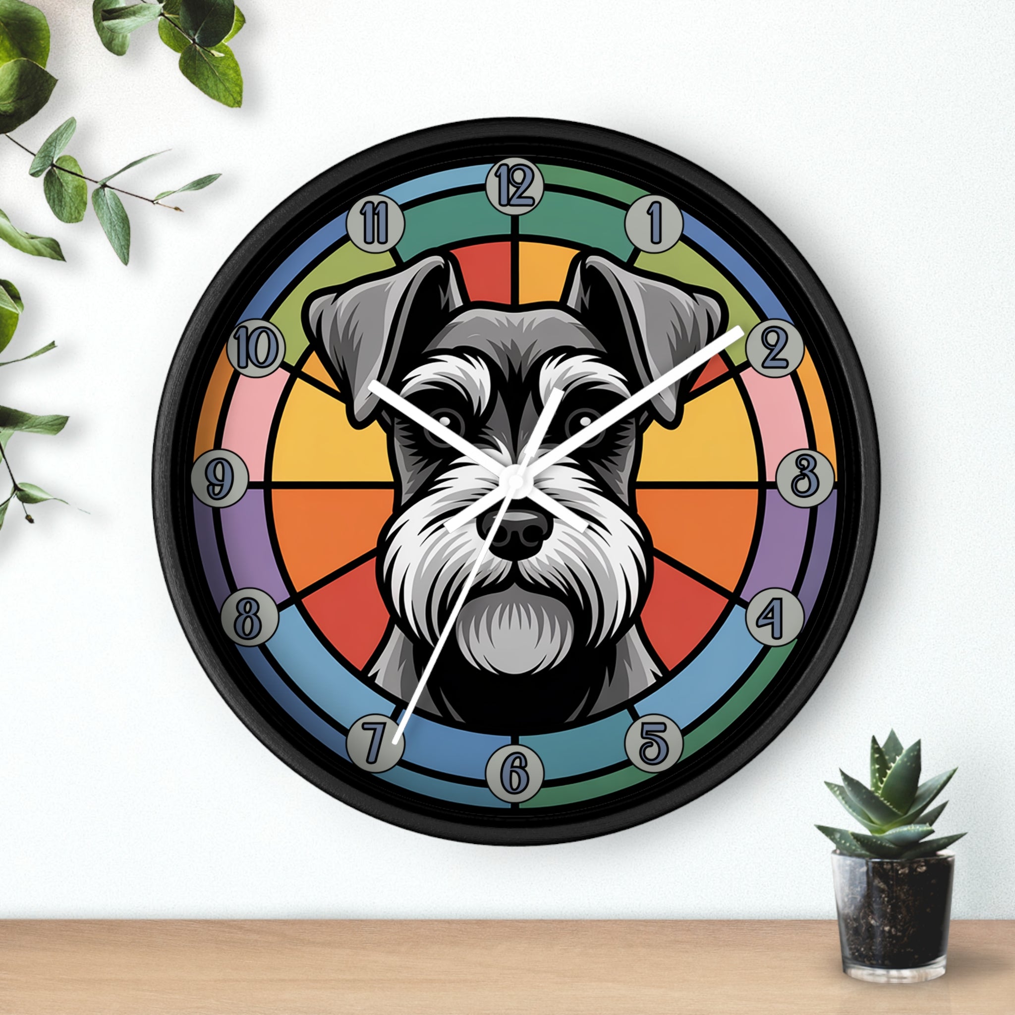 Wall clock with a dog's face design on a colorful background, placed on a white wall with a plant and small pot visible.