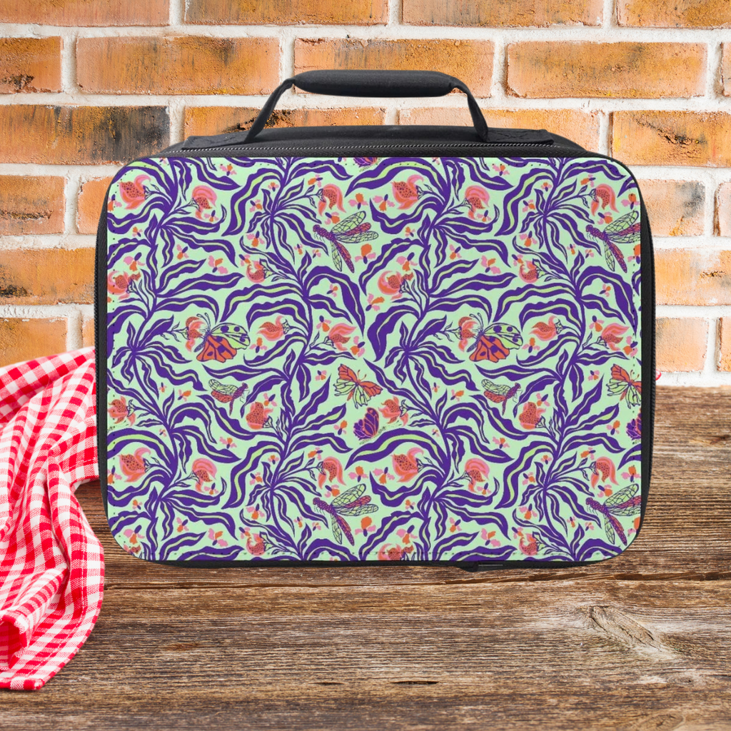 Floral patterned lunch bag on a wooden picnic table with a brick wall background