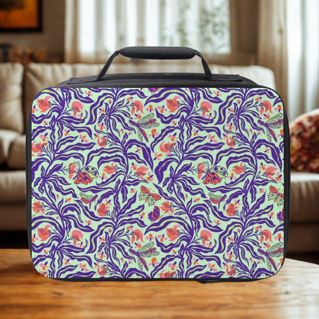 Rectangular lunch bag with floral and insect pattern on a wooden surface.