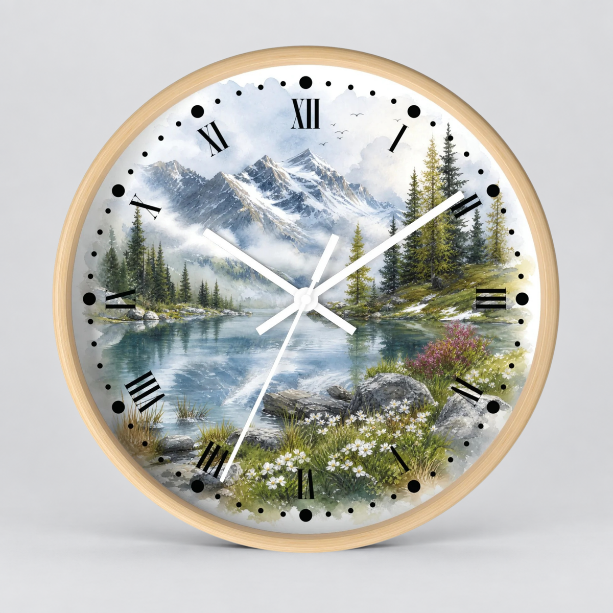 Round wall clock with a light wood frame and a scenic landscape print featuring mountains, a lake, pine trees, and wildflowers. The clock face has black Roman numerals and black hour markers with white hands, shown against a light gray background.