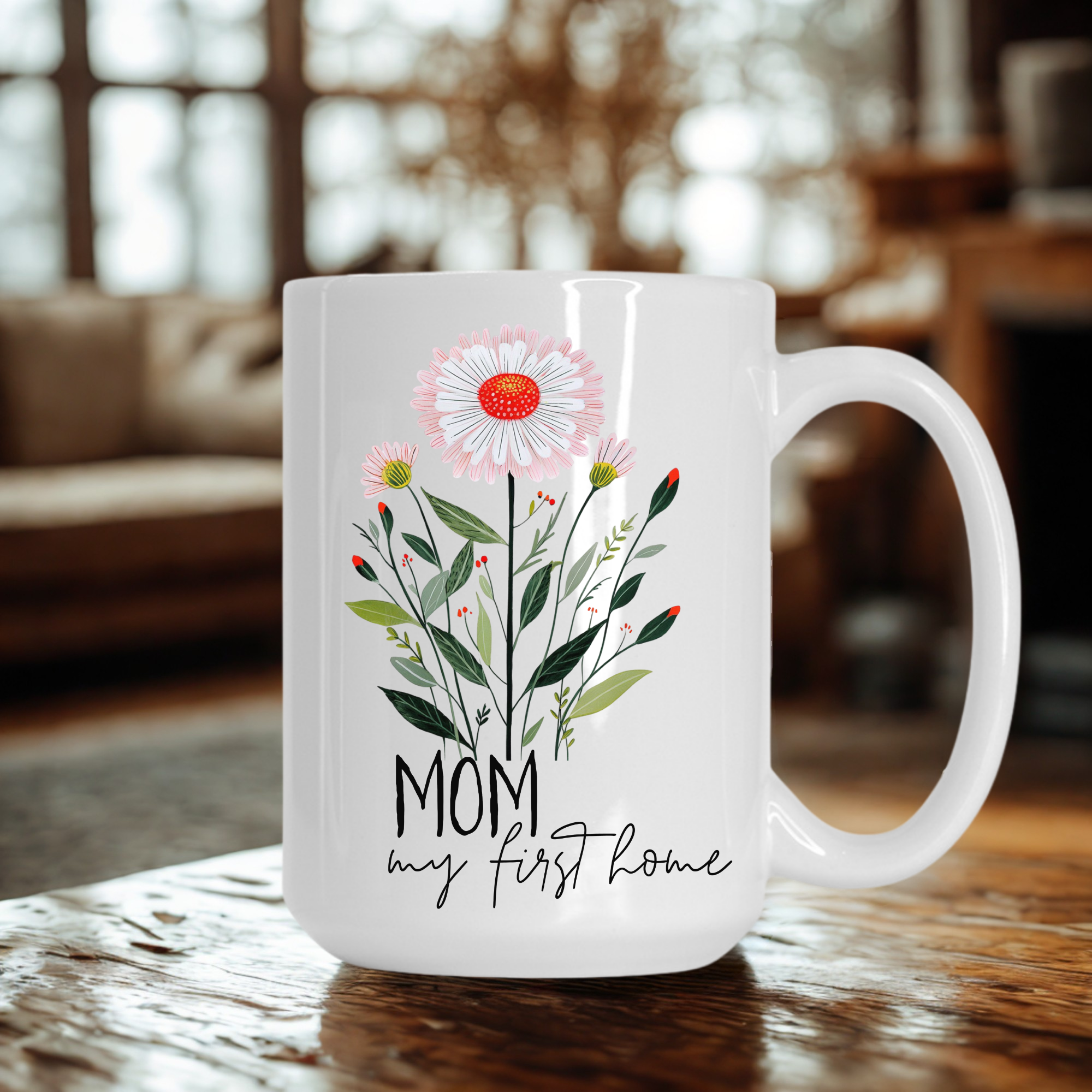 White 15oz mug with floral design and 'Mom my first home' text on a wooden table.