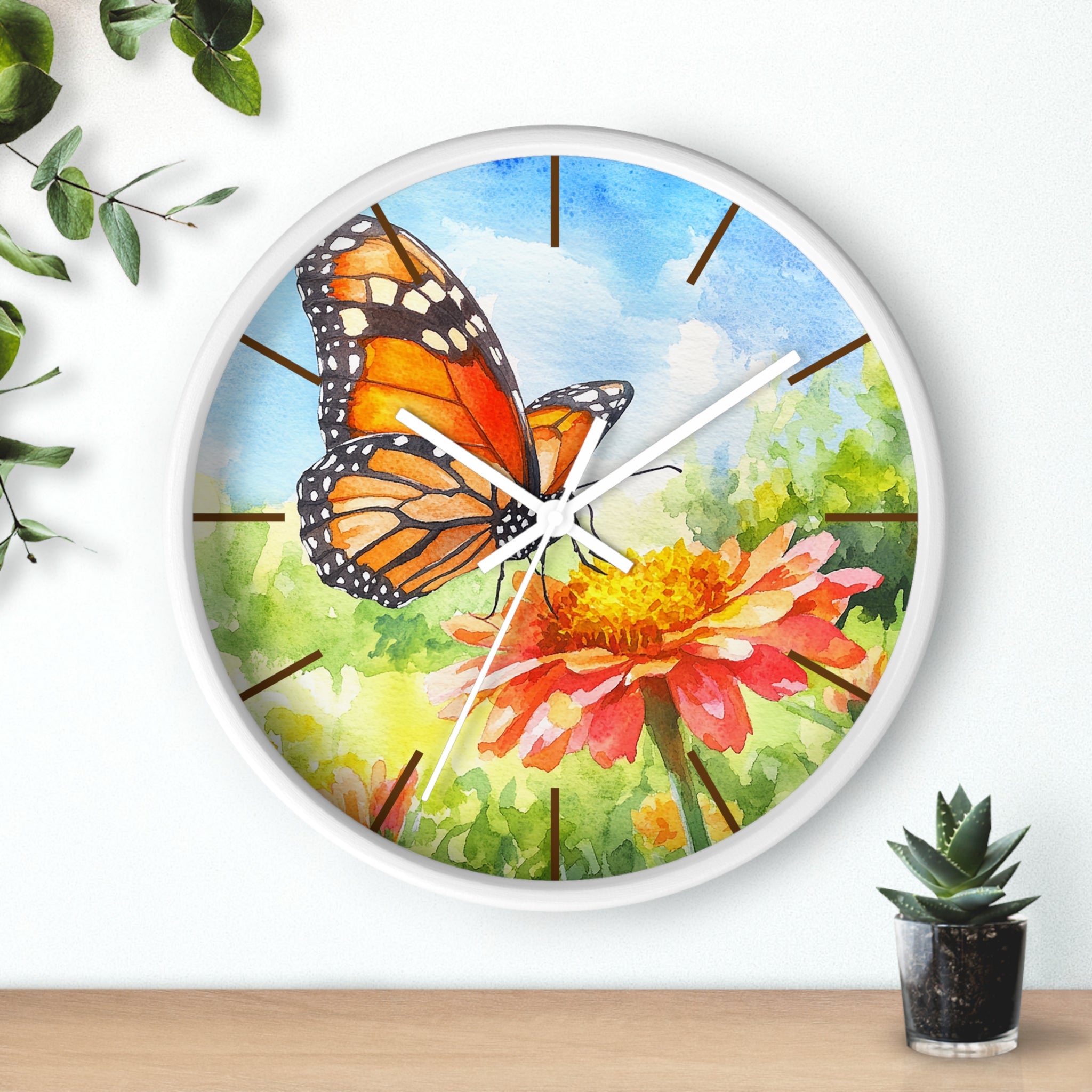White Wall clock with butterfly and flower design on a white background